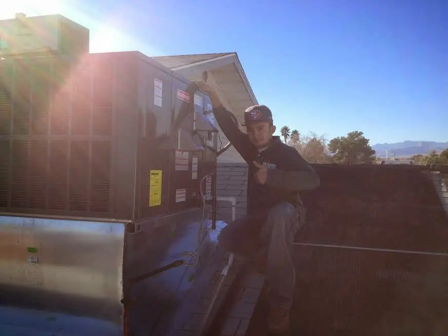 HVAC technician performing HVAC Inspection on a rooftop unit in Fairview